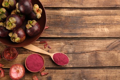 Purple mangosteen powder and fruits on wooden table, flat lay. Space for text