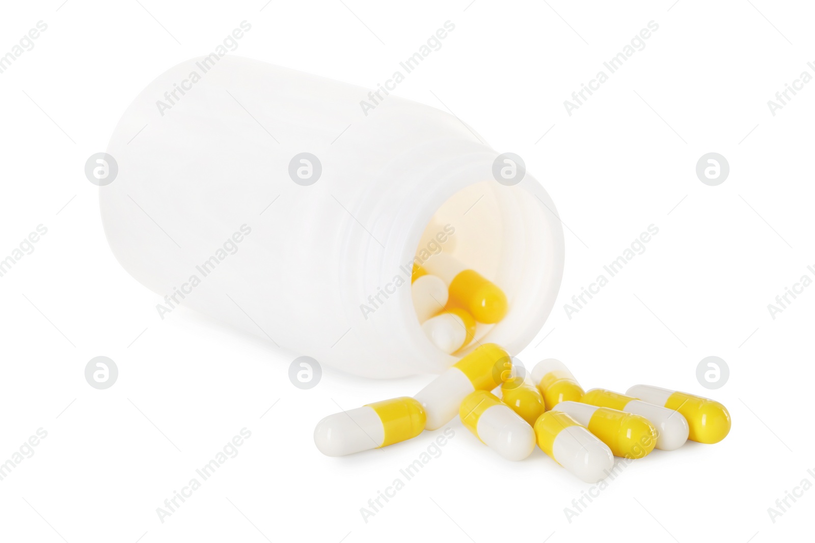 Photo of Scattered antibiotic pills and bottle isolated on white