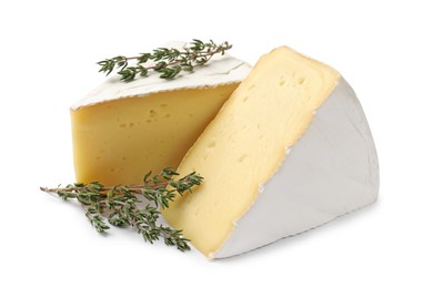 Piece of tasty camembert cheese and thyme isolated on white