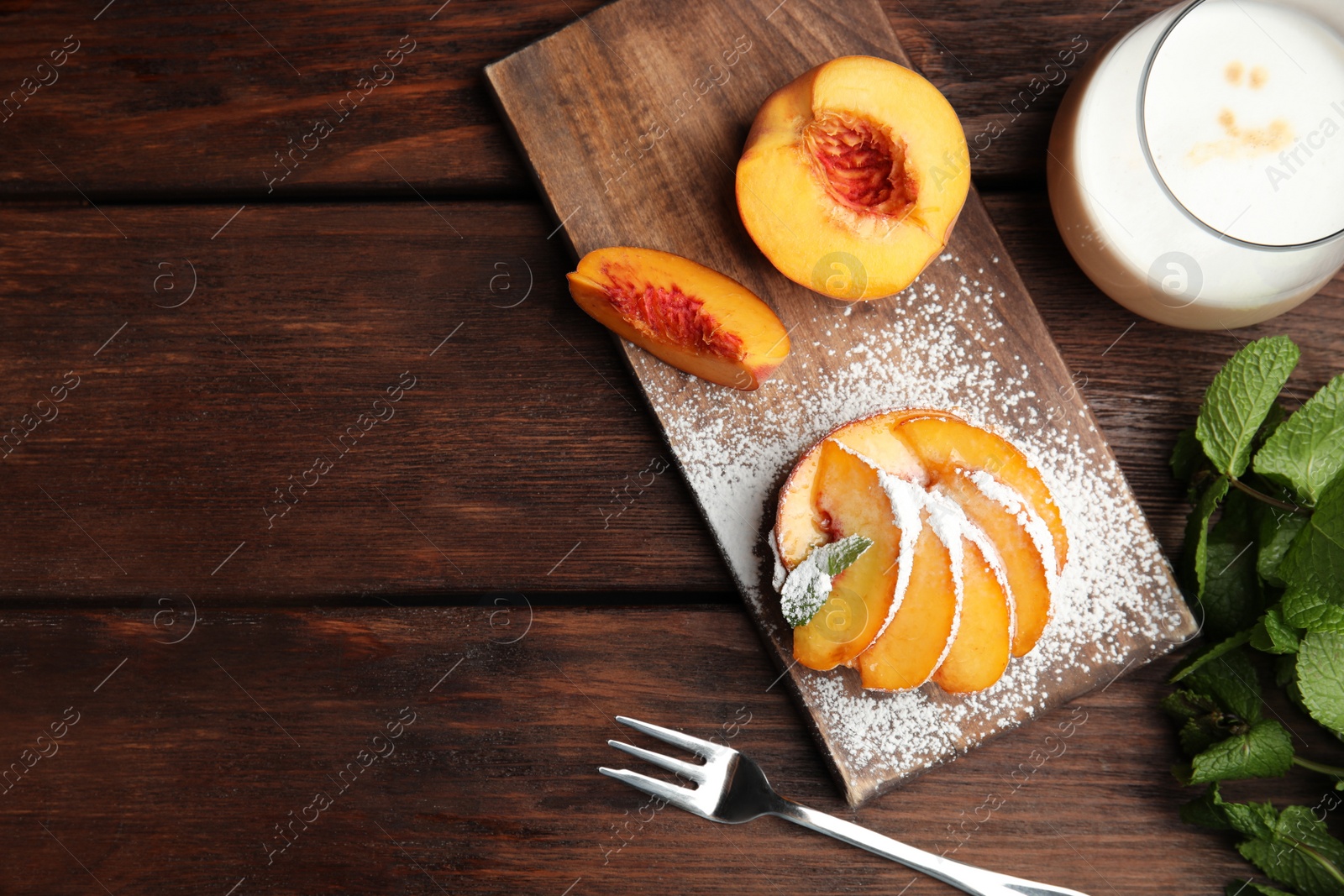 Photo of Delicious peach dessert on wooden table, flat lay. Space for text