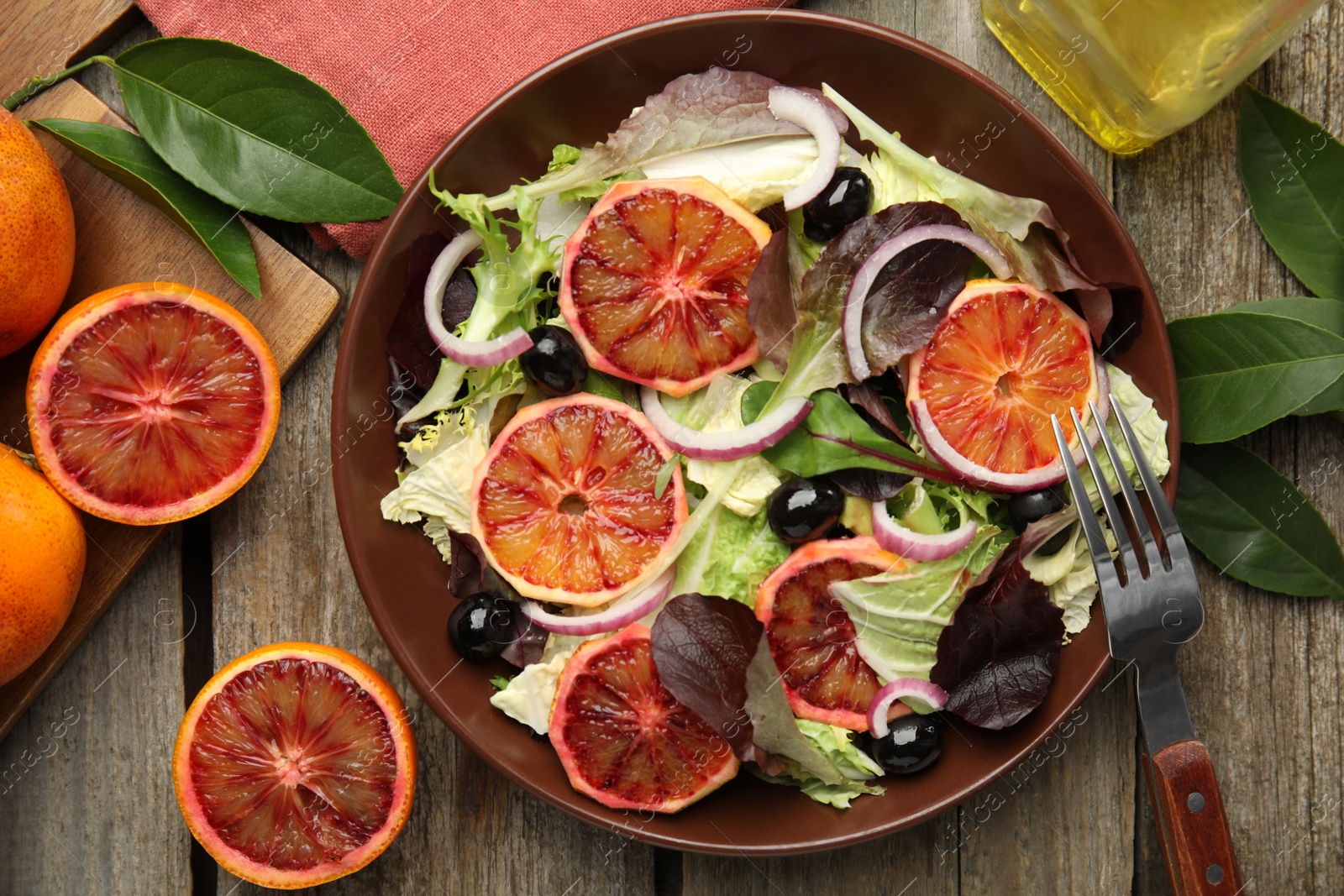 Photo of Delicious sicilian orange salad served on wooden table, flat lay