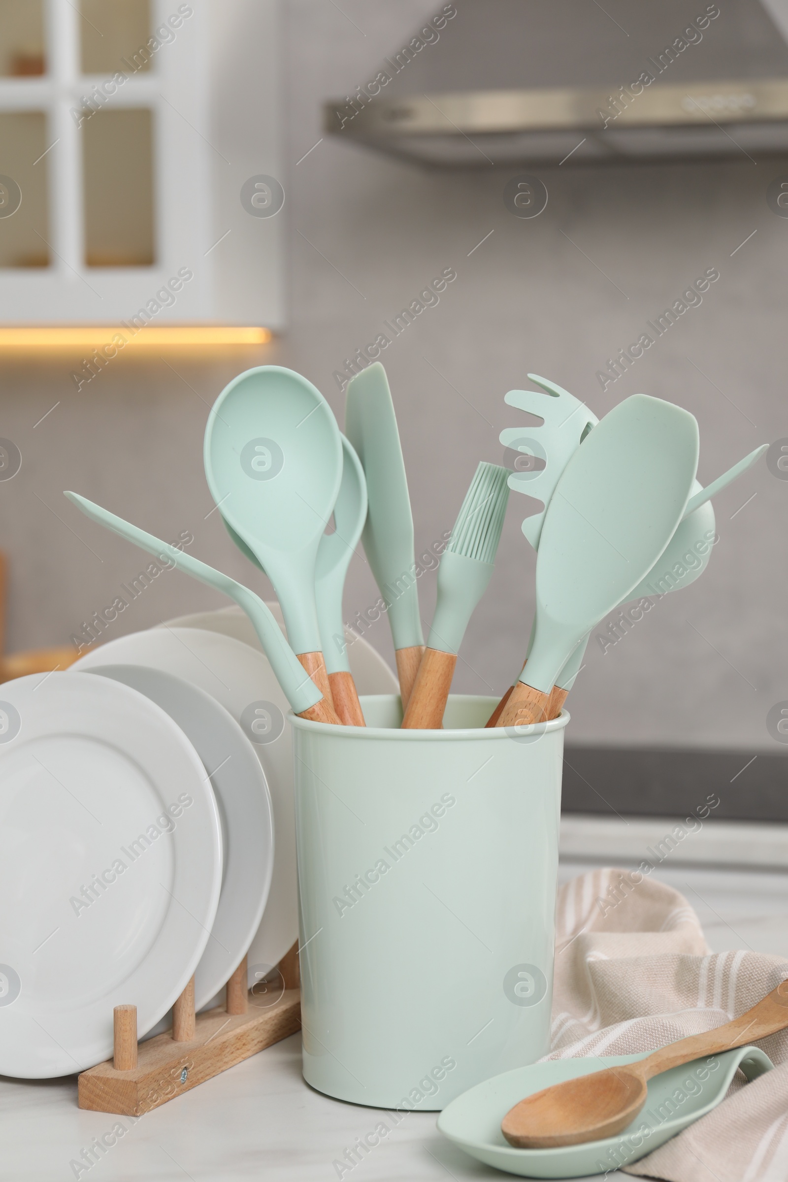 Photo of Set of different kitchenware on white table at home