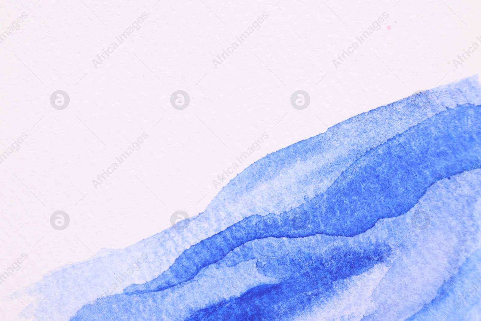 Photo of Abstract blue watercolor painting on white paper, top view. Space for text