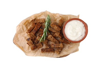 Photo of Crispy rusks with rosemary and sauce isolated on white, top view