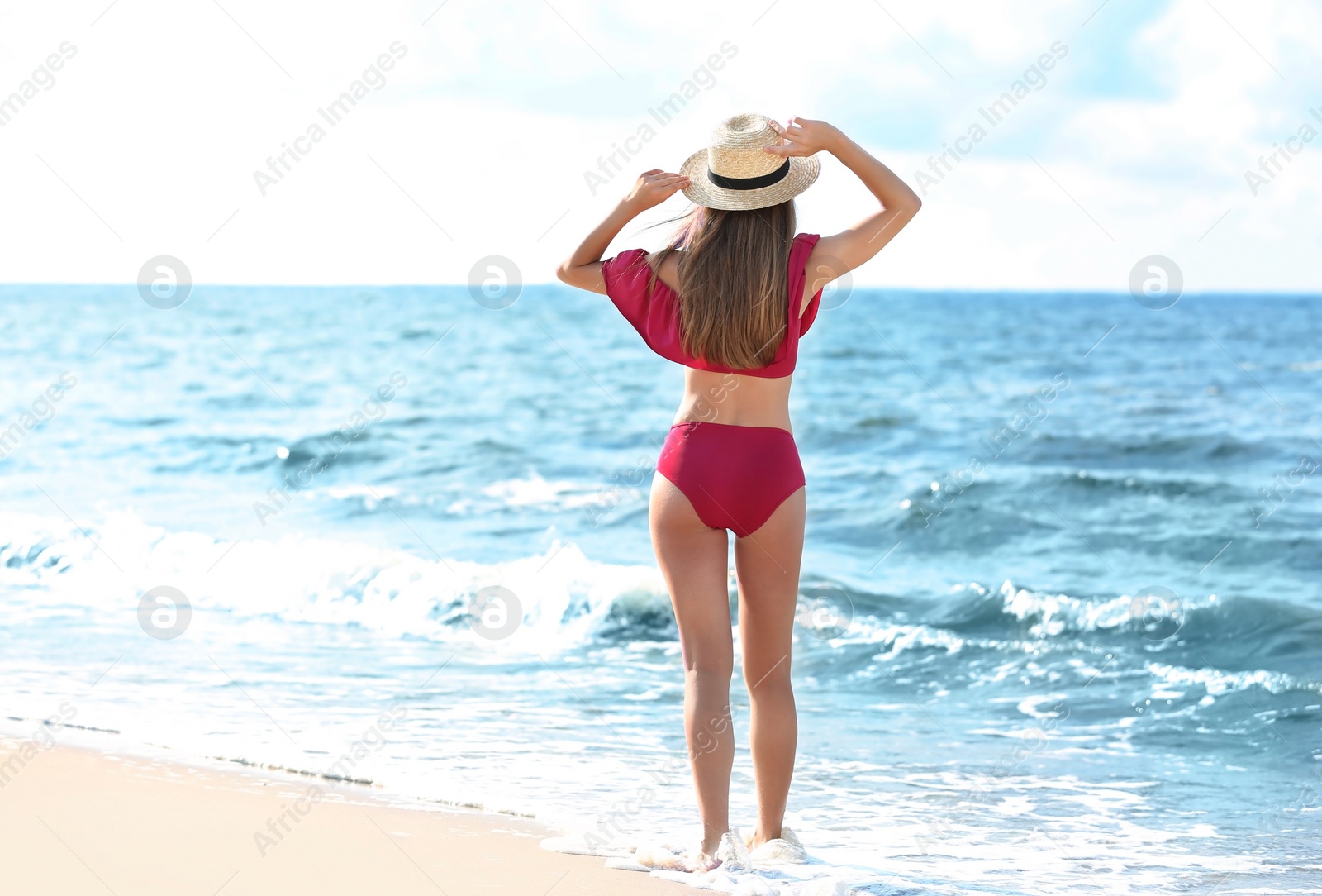 Photo of Attractive young woman in beautiful bikini swimsuit on beach