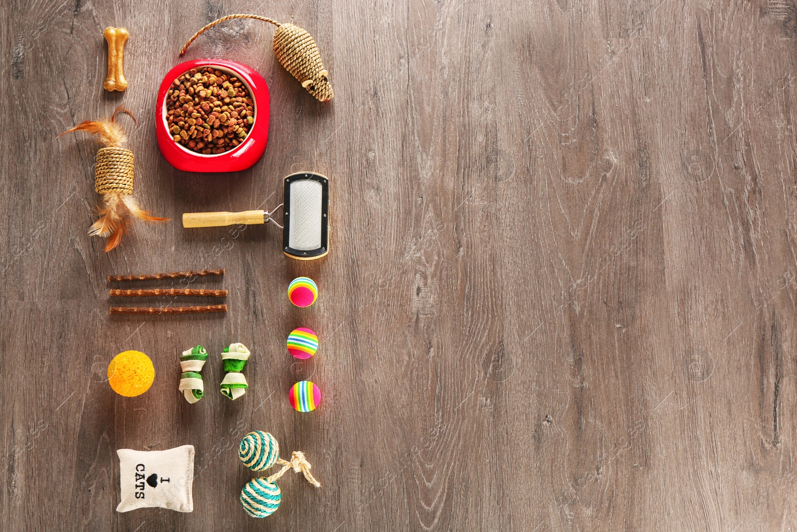 Photo of Flat lay composition with cat accessories and food on wooden background