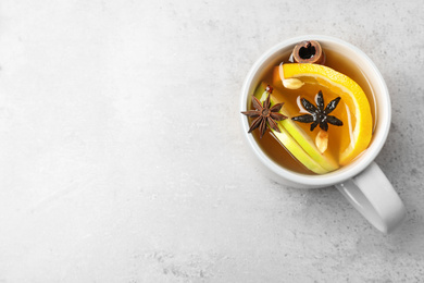 Photo of Aromatic white mulled wine on light grey table, top view. Space for text