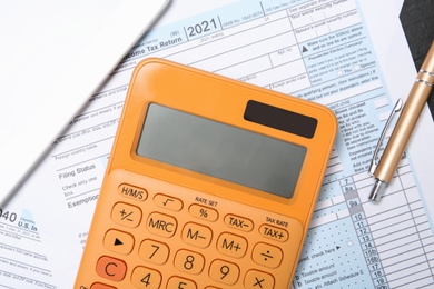 Photo of Flat lay composition with calculator and documents on table. Tax accounting