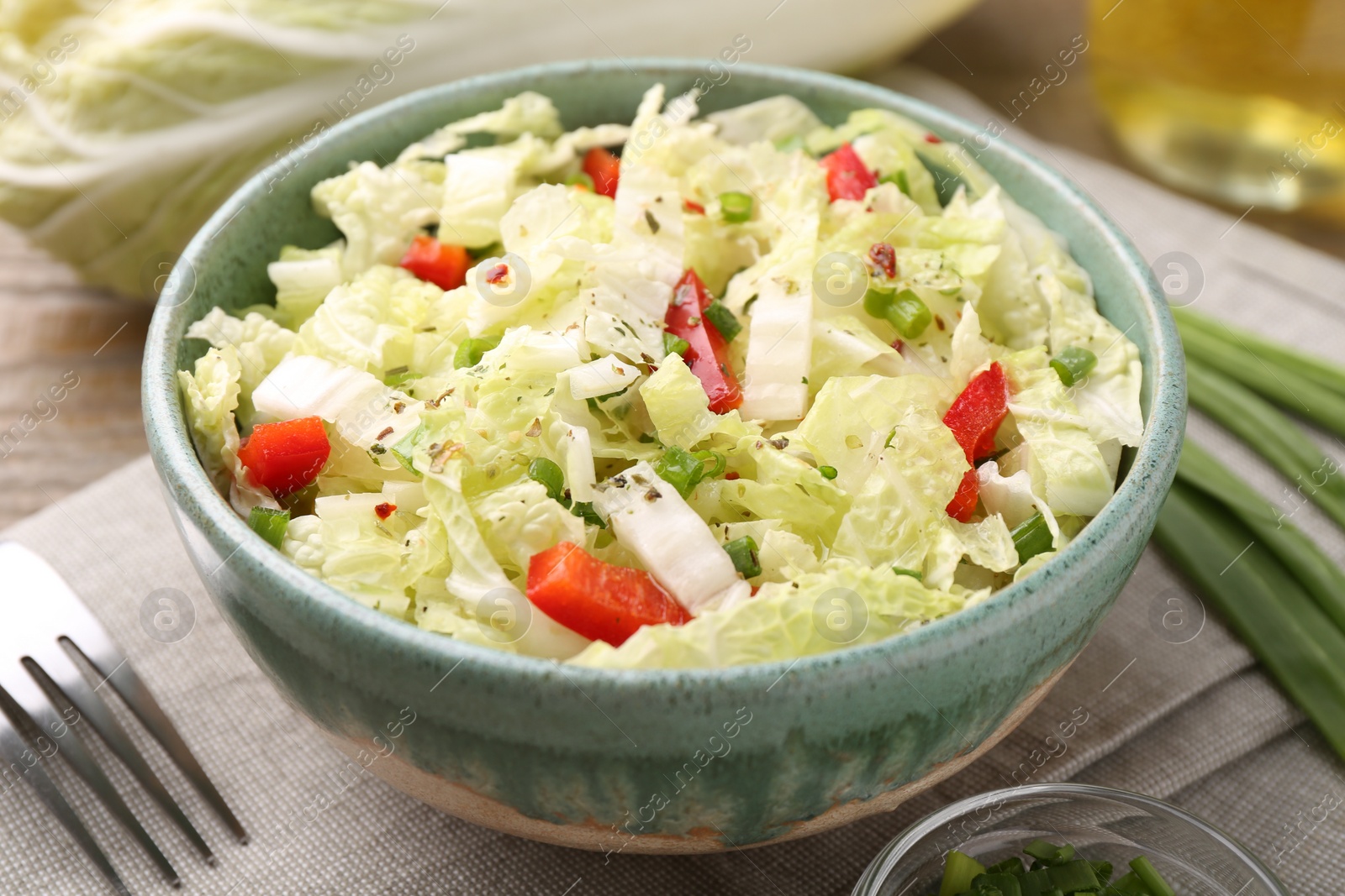 Photo of Tasty salad with Chinese cabbage in bowl on table, closeup