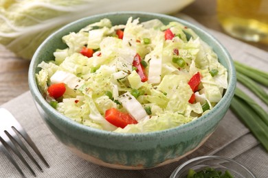 Photo of Tasty salad with Chinese cabbage in bowl on table, closeup