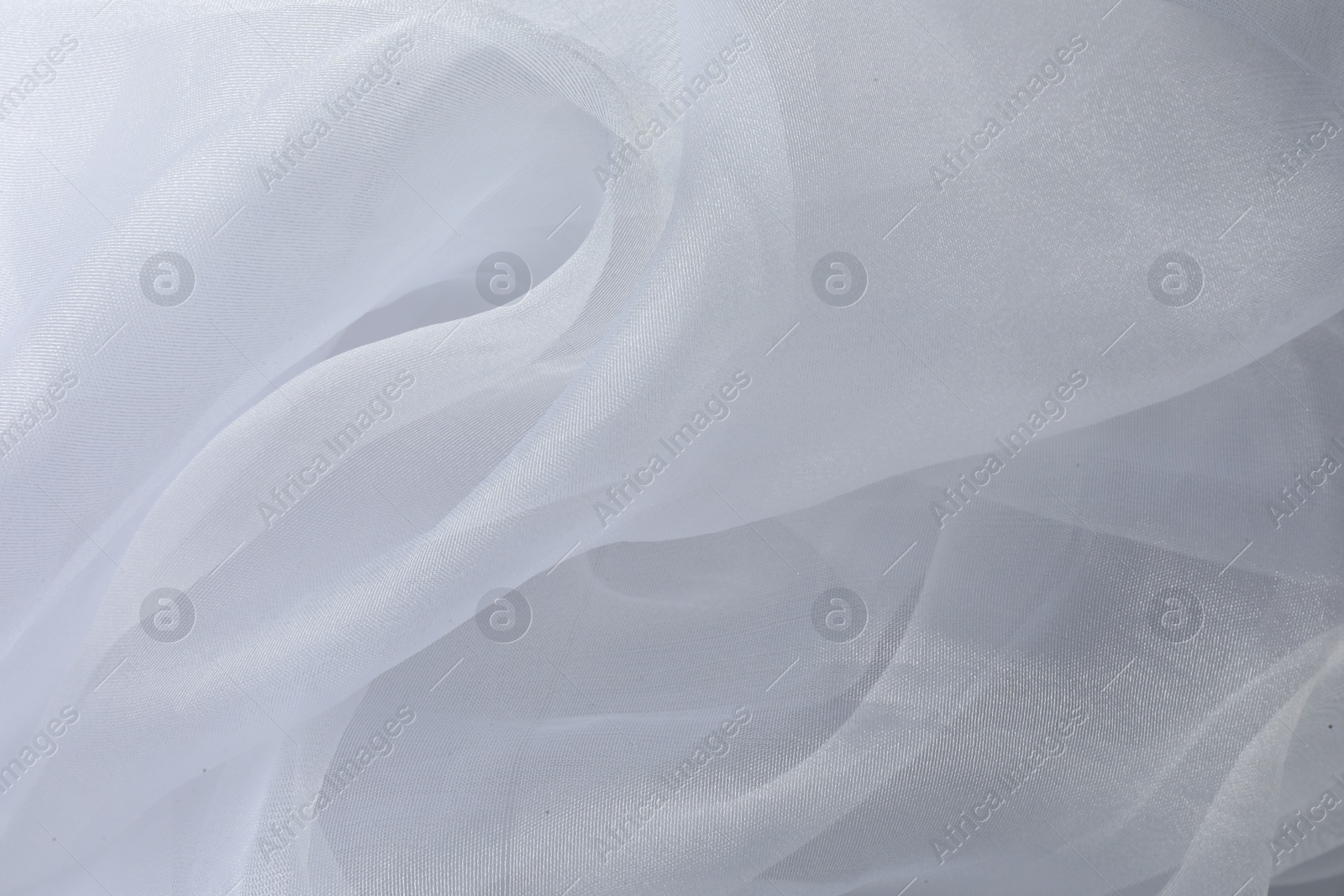 Photo of Texture of white tulle fabric as background, top view