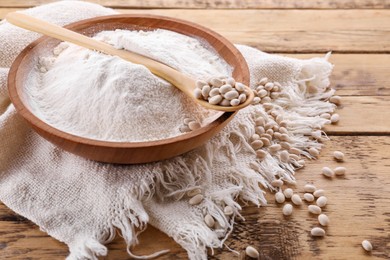 Photo of Kidney bean flour and seeds on wooden table