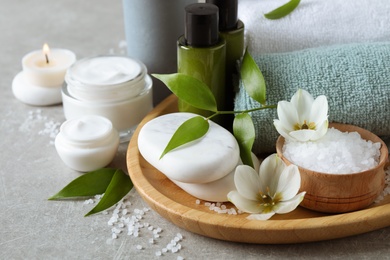 Photo of Spa composition with skin care products on textured table, closeup