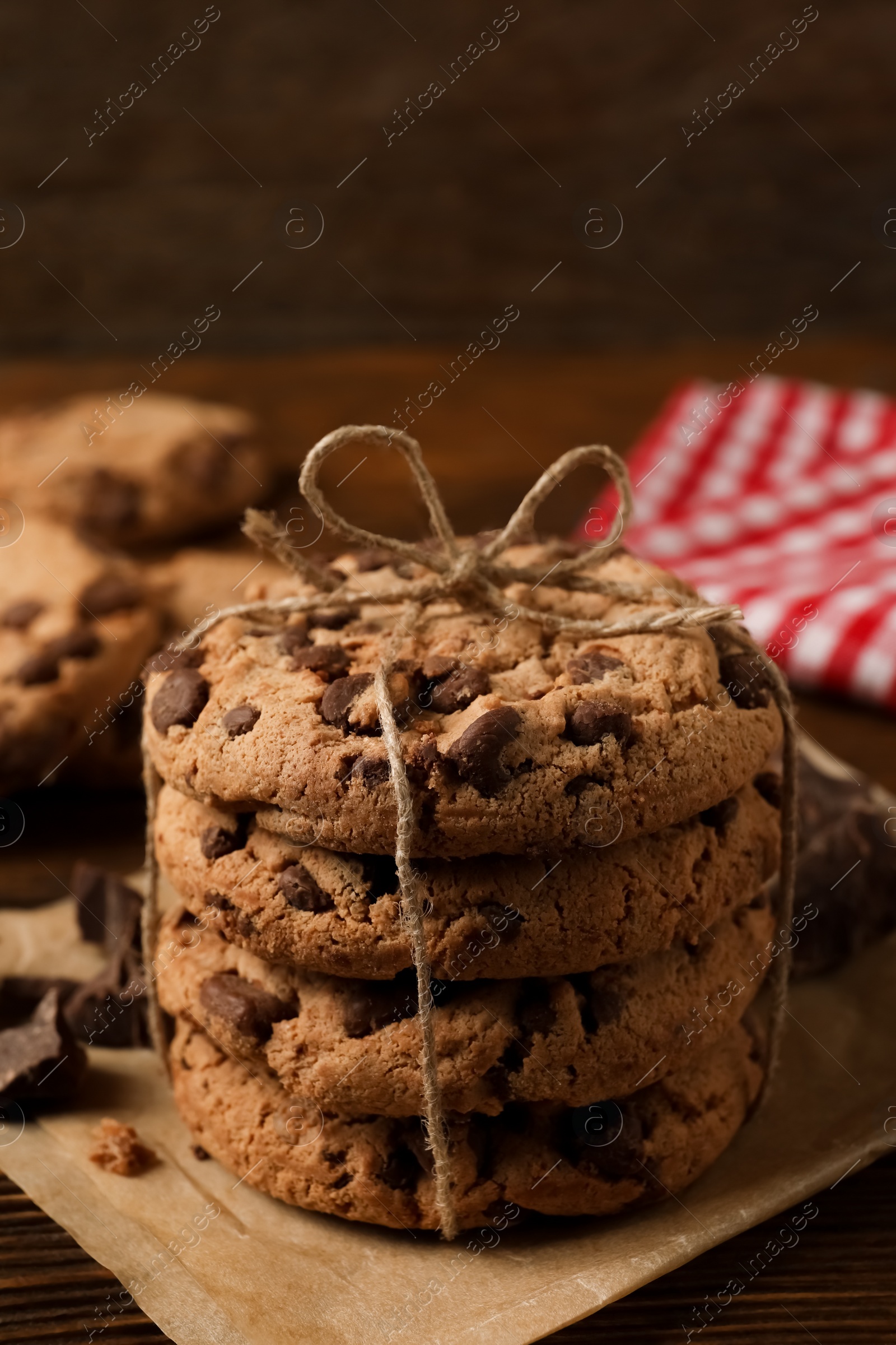 Photo of Many delicious chocolate chip cookies on wooden table, closeup