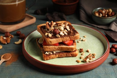 Photo of Tasty toasts with chocolate spread, nuts, strawberries and banana served on wooden table