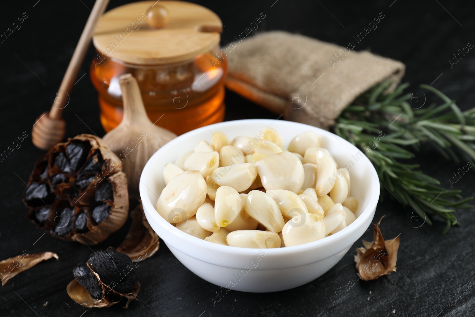 Photo of Fresh and fermented black garlic on table