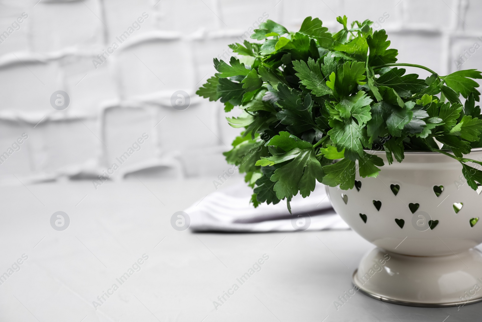 Photo of Fresh green parsley on table. Space for text