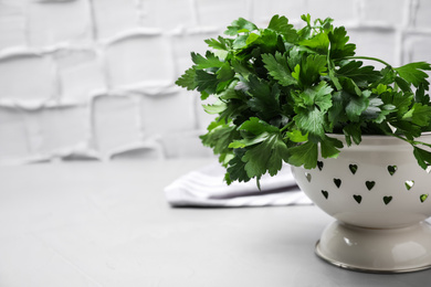 Photo of Fresh green parsley on table. Space for text