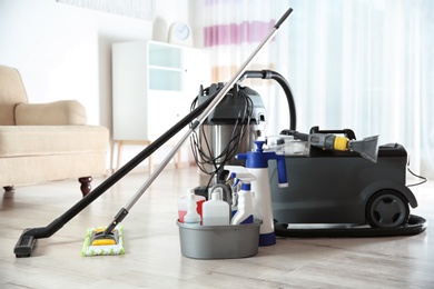 Photo of Professional cleaning supplies and equipment on floor indoors