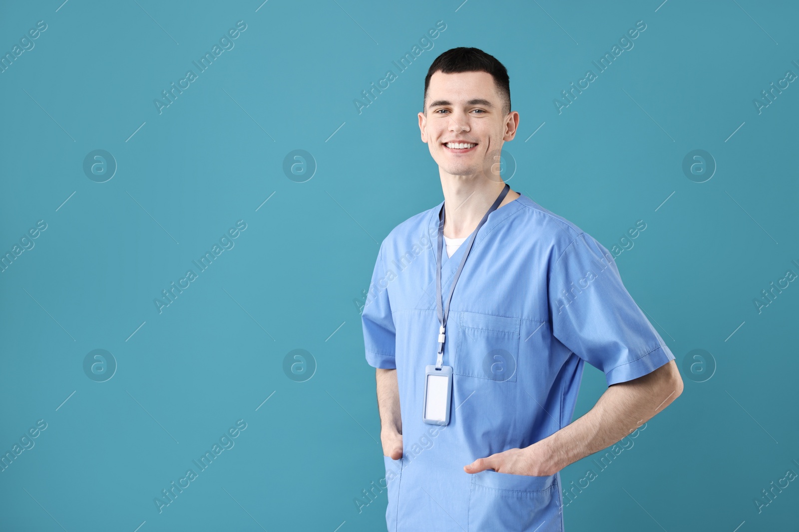 Photo of Portrait of smiling medical assistant on light blue background. Space for text