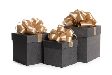 Photo of Black gift boxes with golden bows on white background