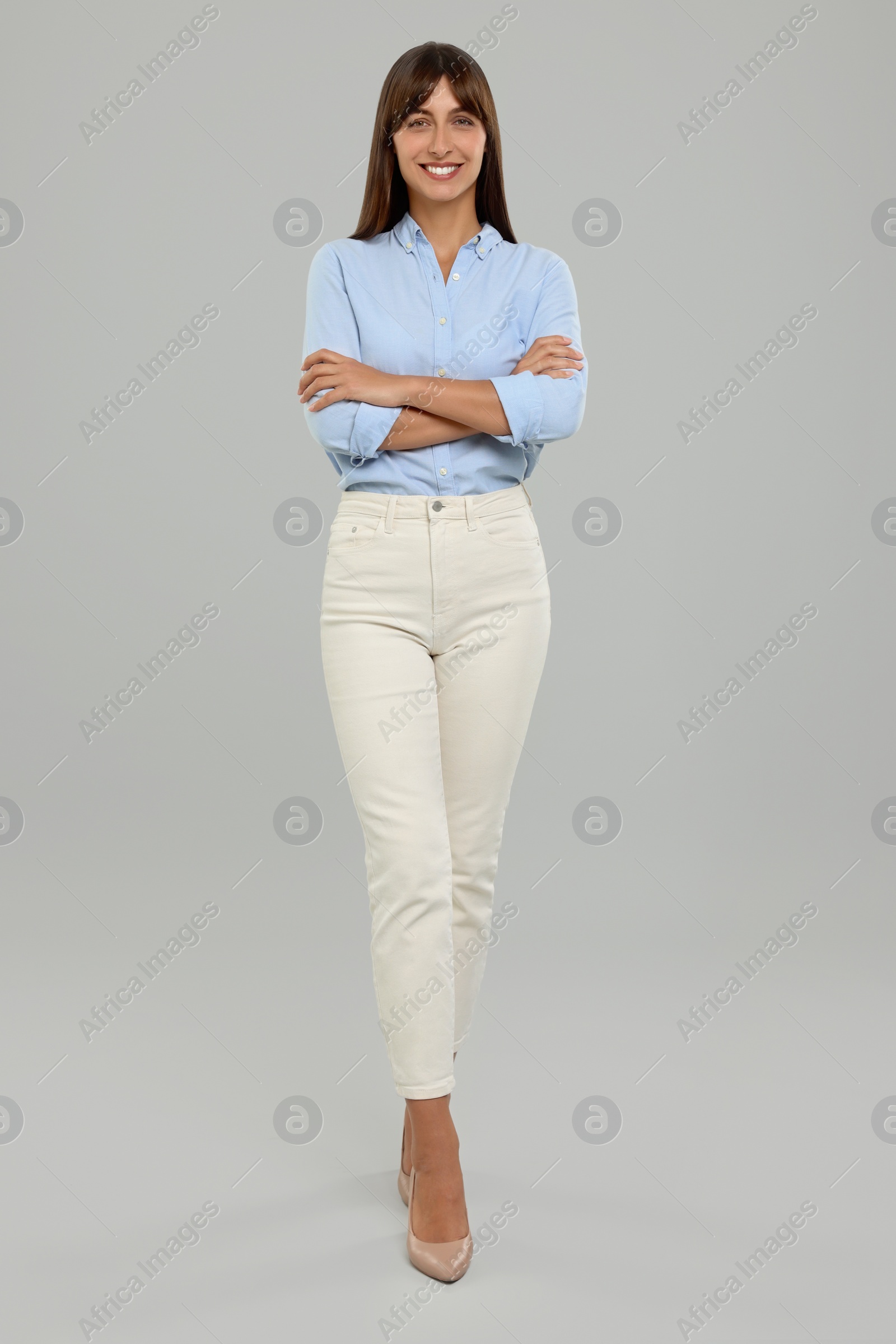 Photo of Full length portrait of happy secretary on light grey background