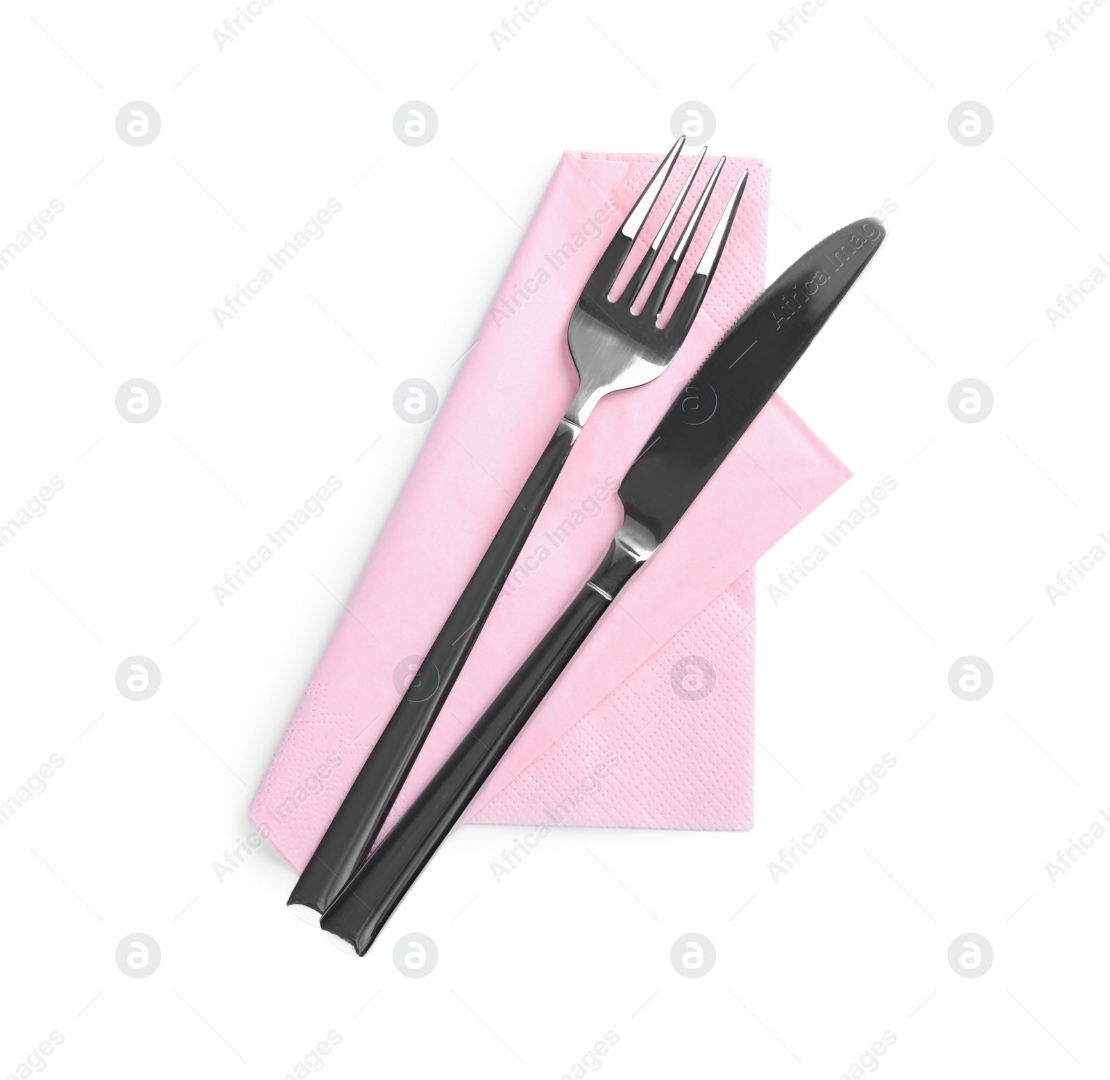 Photo of Pink napkin with fork and knife on white background, top view
