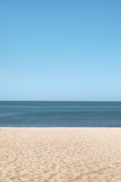 Sandy beach near sea on sunny summer day