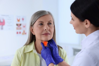 Endocrinologist examining thyroid gland of patient at hospital