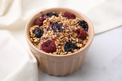 Tasty baked oatmeal with berries on white table, closeup