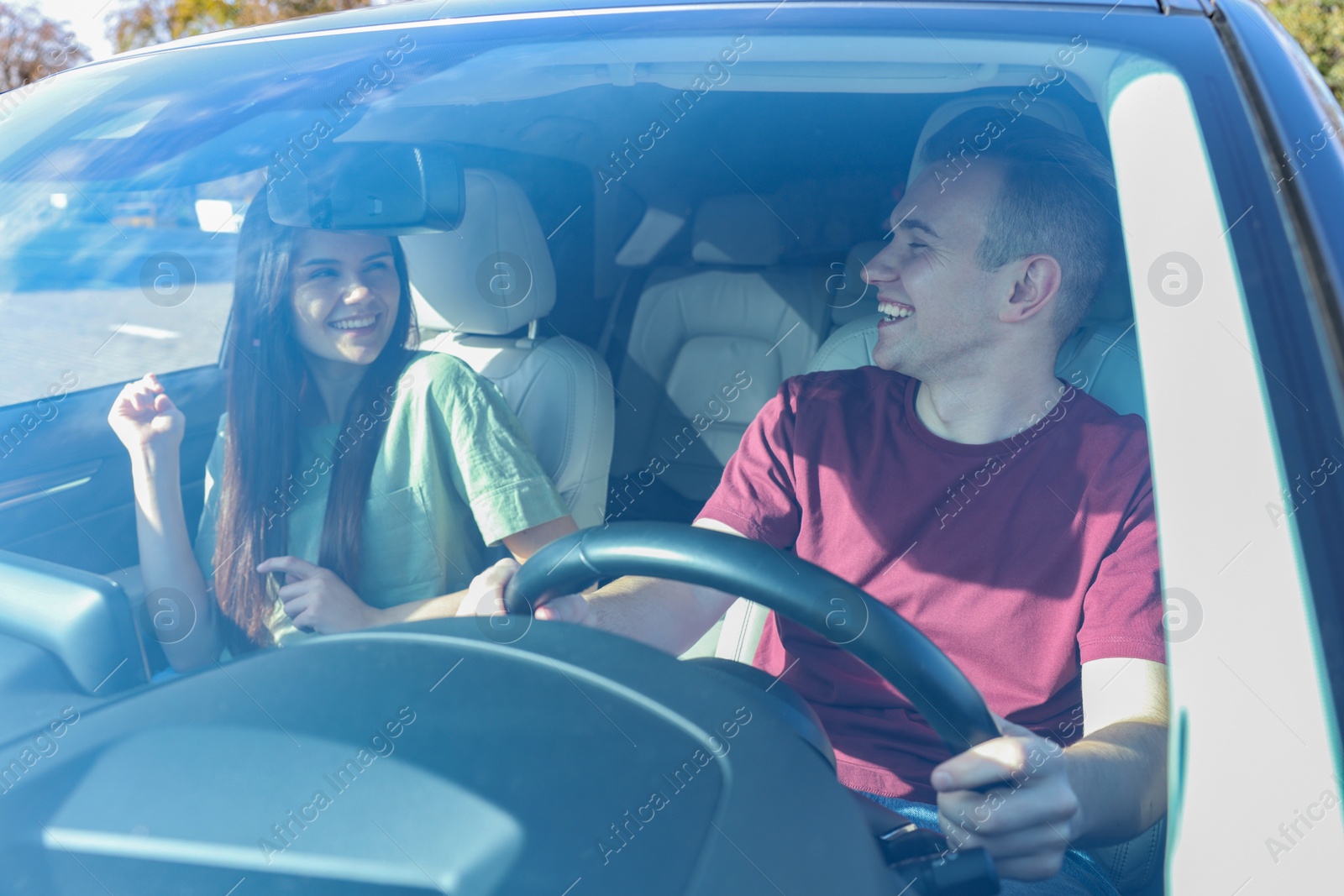 Photo of Happy young couple travelling together by car