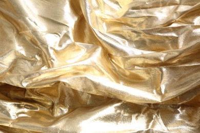 Photo of Closeup view of golden shiny fabric as background