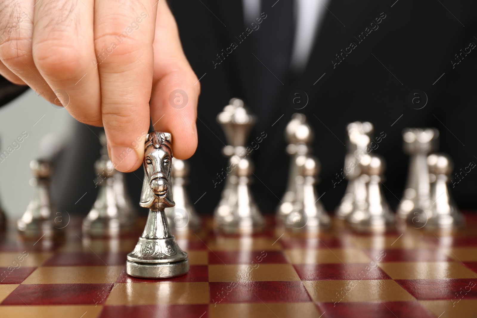 Photo of Man moving chess piece on board, closeup