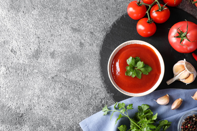 Photo of Flat lay composition with tomato sauce on grey table, space for text