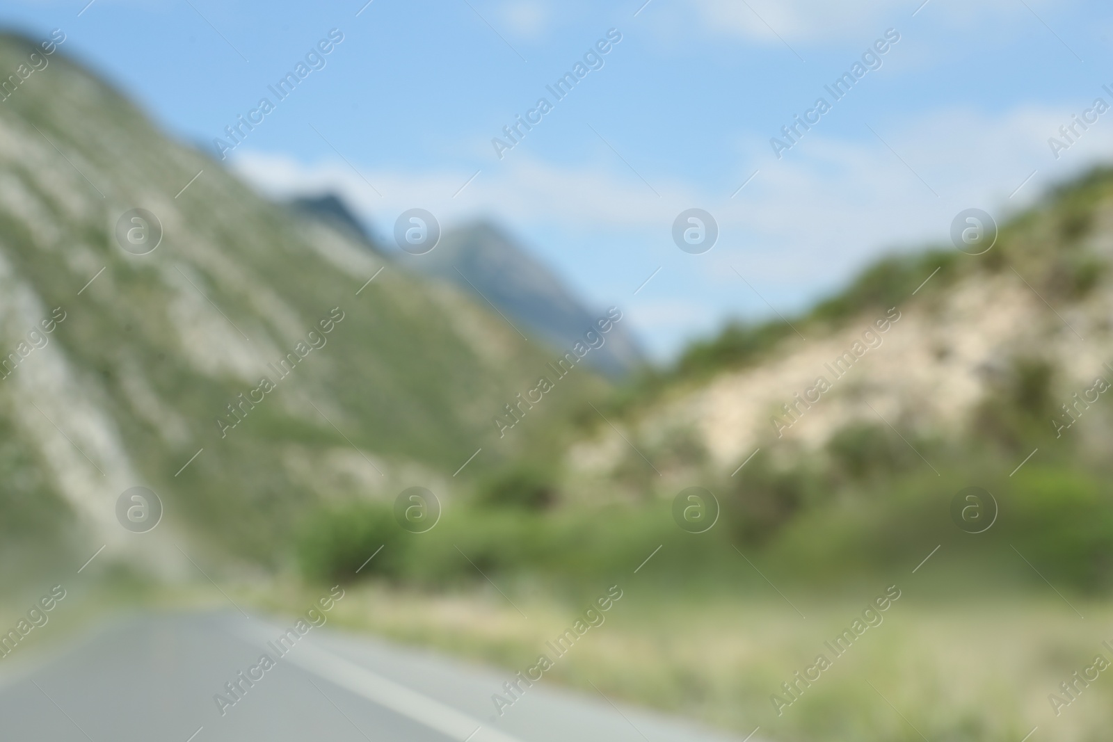 Photo of Blurred view of mountains and empty asphalt highway outdoors. Road trip