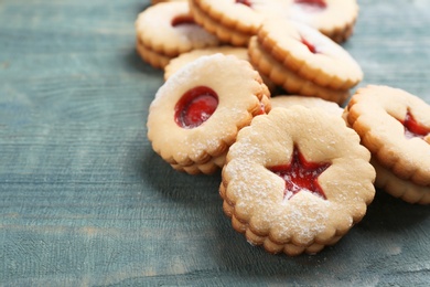 Traditional Christmas Linzer cookies with sweet jam on wooden background