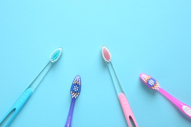 Photo of Flat lay composition with manual toothbrushes on color background