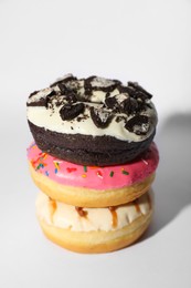 Photo of Sweet tasty glazed donuts on white background, closeup