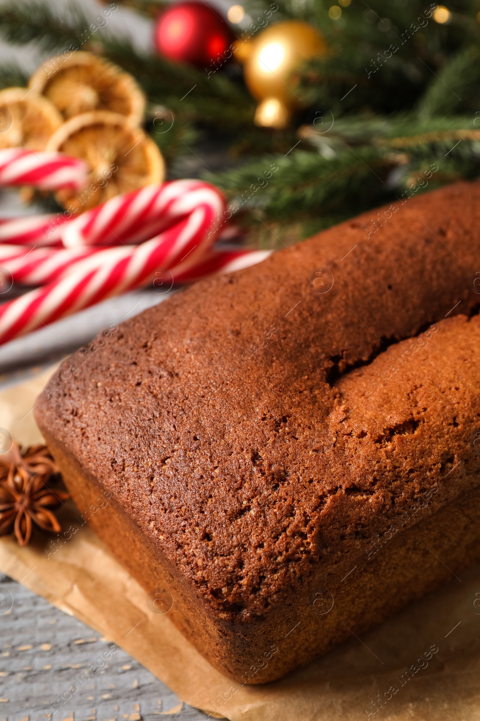 Photo of Delicious gingerbread cake and Christmas items on wooden table