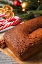 Delicious gingerbread cake and Christmas items on wooden table