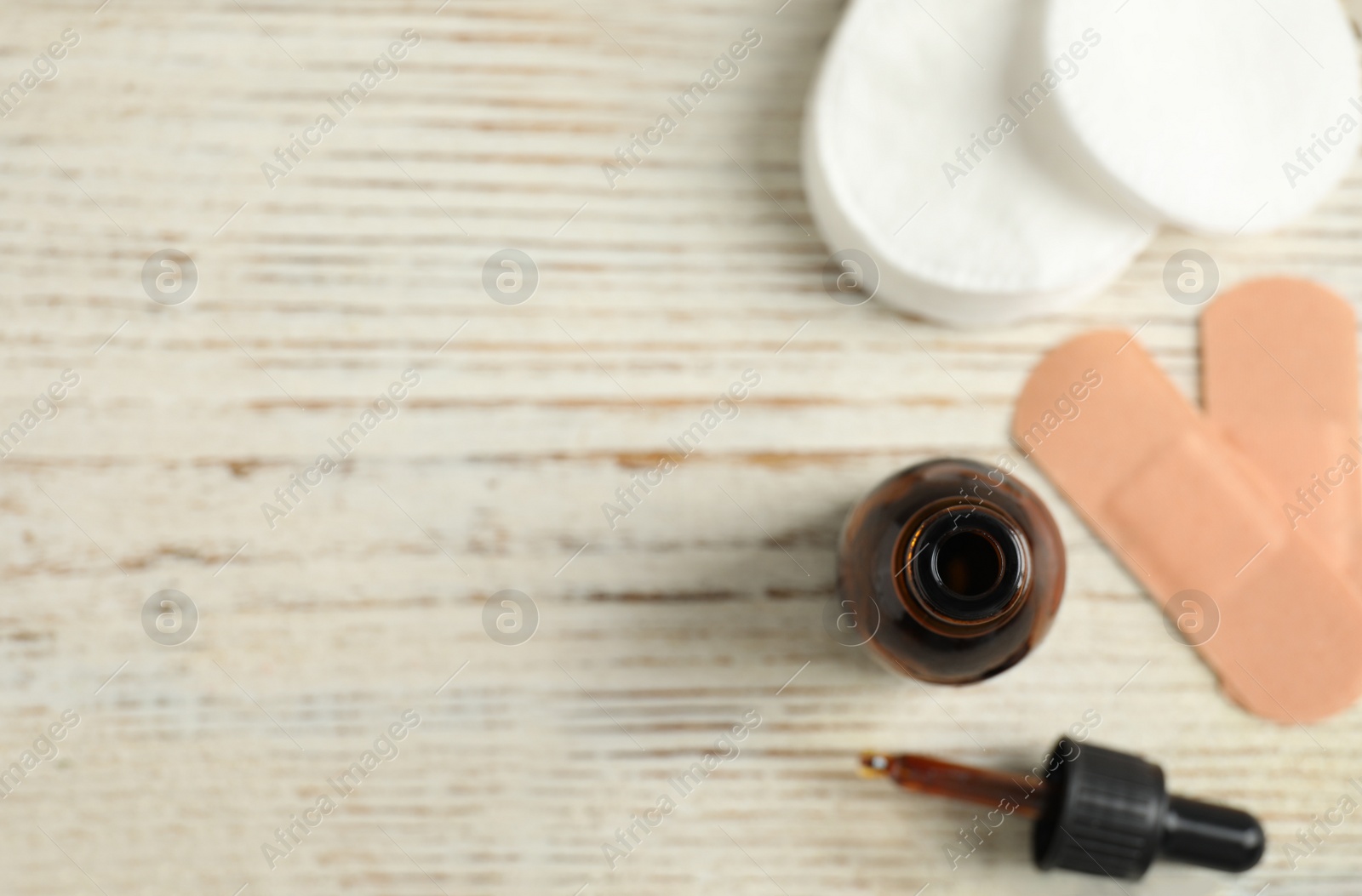 Photo of Flat lay composition with bottle of medical iodine on white wooden table. Space for text