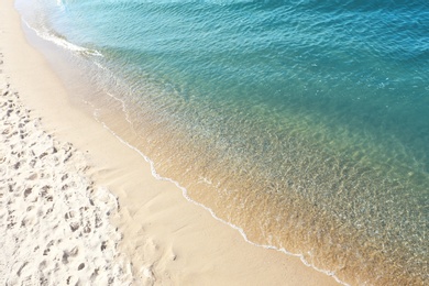 Sandy beach near sea on sunny day