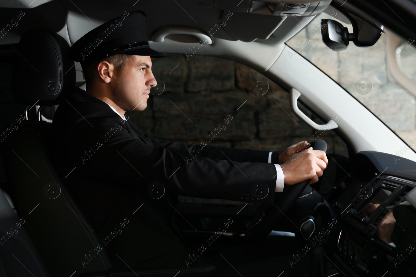 Photo of Professional driver in luxury car. Chauffeur service