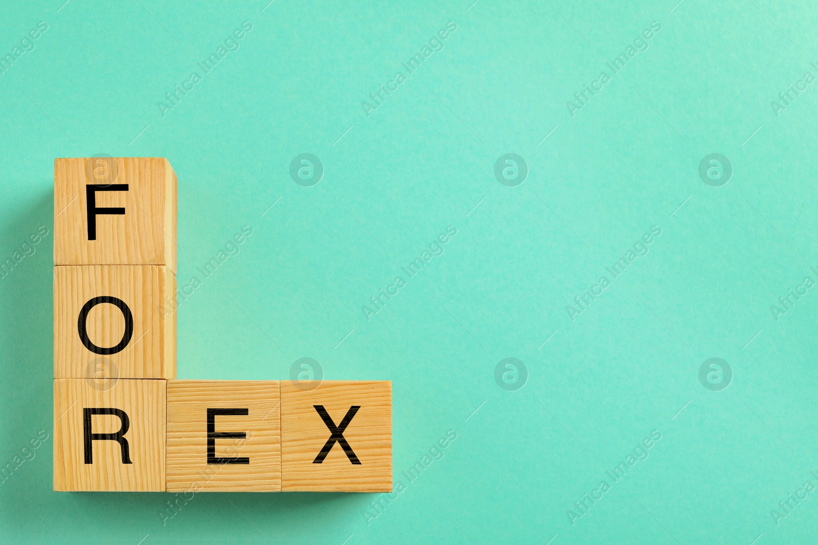 Photo of Word Forex made with wooden cubes on light blue background, flat lay. Space for text