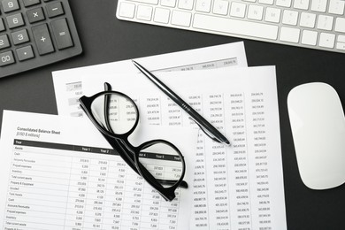 Photo of Flat lay composition with accounting documents and glasses on black table