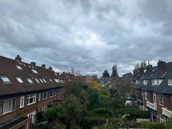 Beautiful view of buildings and trees in city on cloudy day