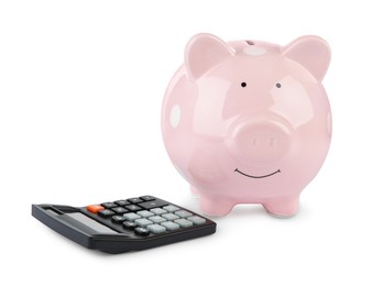 Photo of Calculator and pink piggy bank isolated on white
