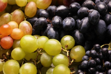 Photo of Fresh ripe juicy grapes as background, closeup