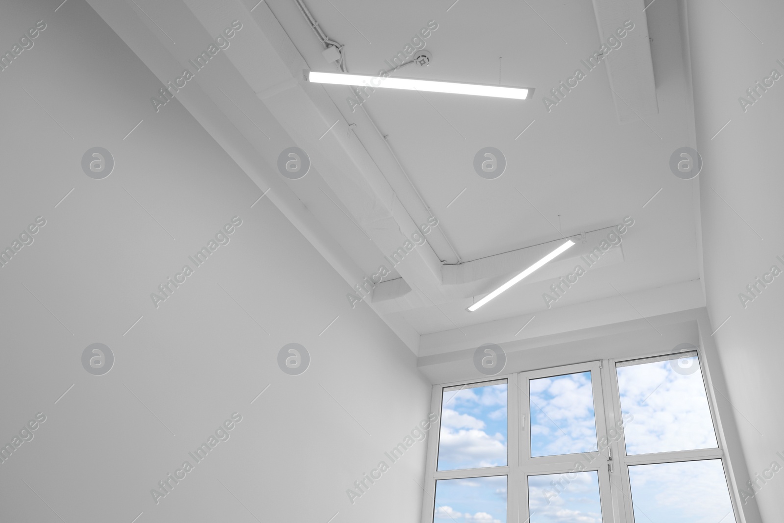 Photo of Ceiling with modern lights in renovated room