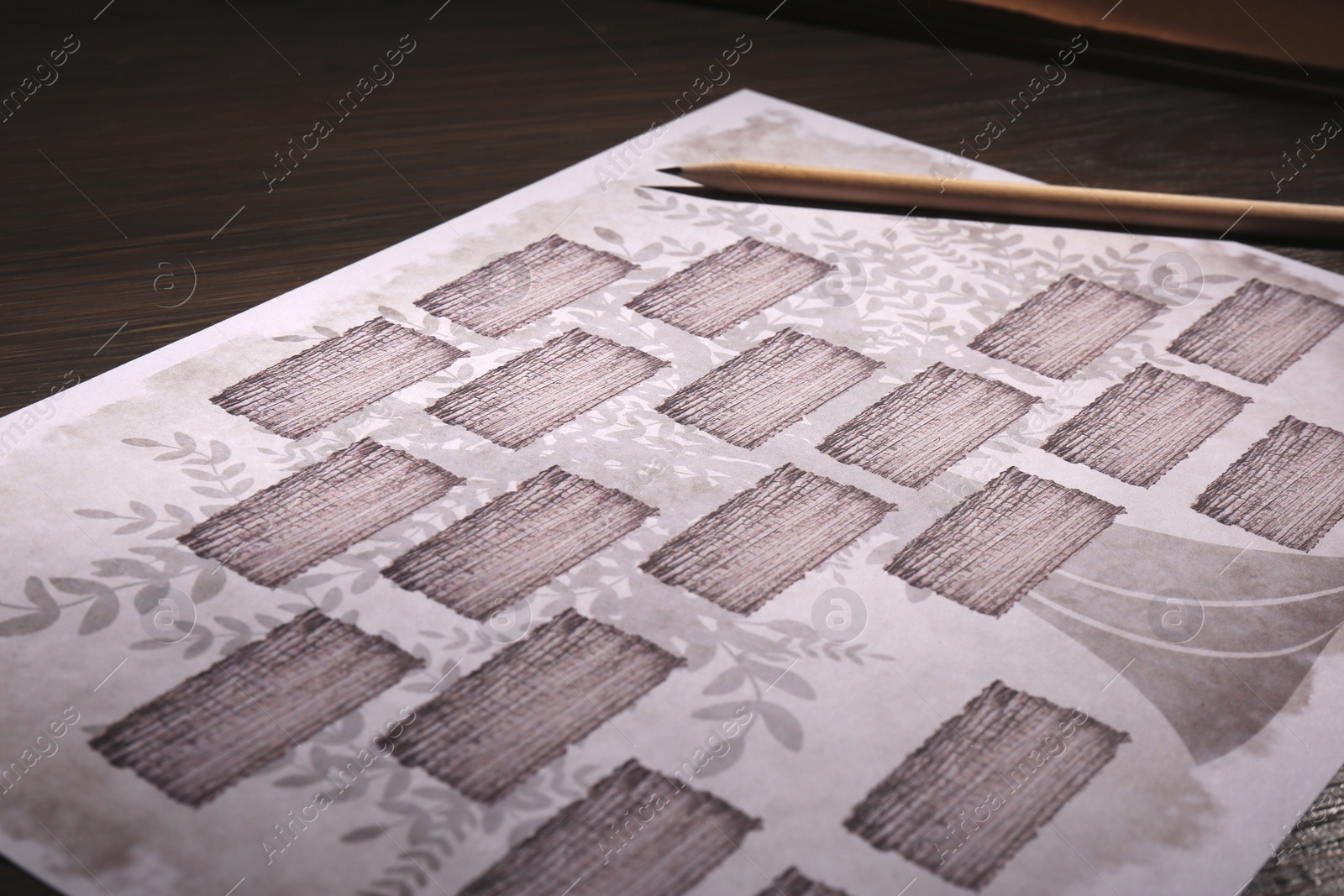 Photo of Blank family tree and pencil on wooden table, closeup